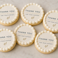 Six round cookies with 'Thank you for your support' text on a marble surface