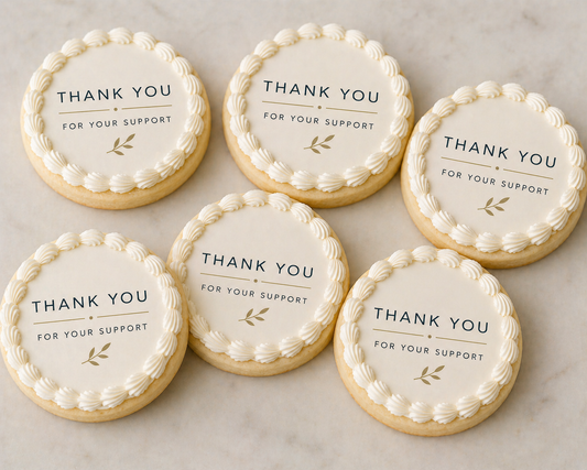 Six round cookies with 'Thank you for your support' text on a marble surface